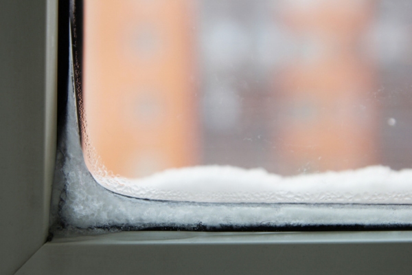 Condensation on the window leading to ice buildup depicting window drafts & inefficiency