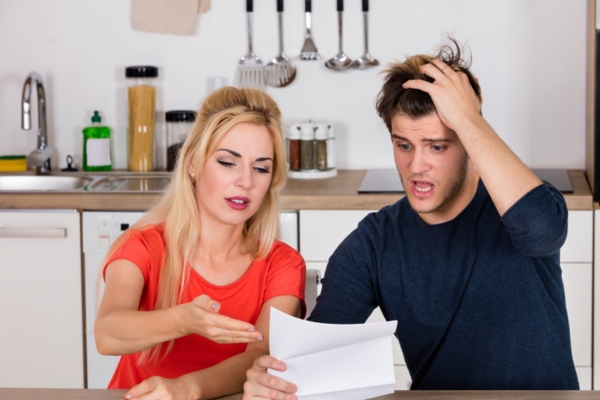 couple shocked while looking at energy bill