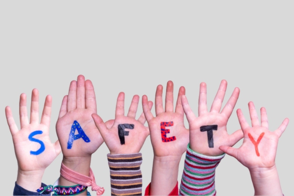 hands of children with safety painted depicting safety tips